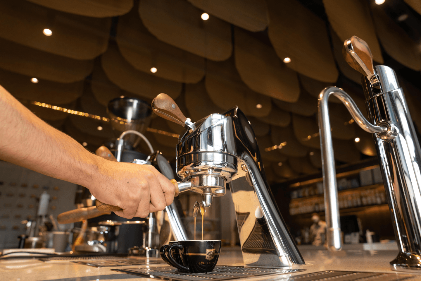 Barista preparing espresso at a café counter